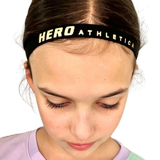 Hero Athletica head band with silicone grip in black worn by a person, designed for all sizes.